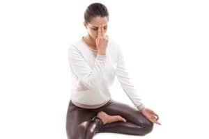 femme pratiquant la respiration alternée un pranayama en yoga